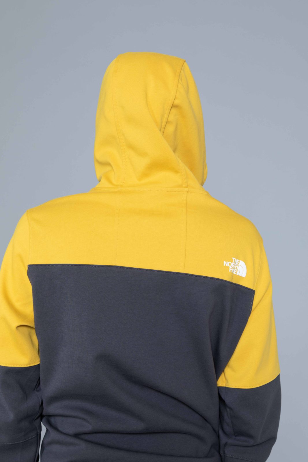 grey and yellow north face hoodie
